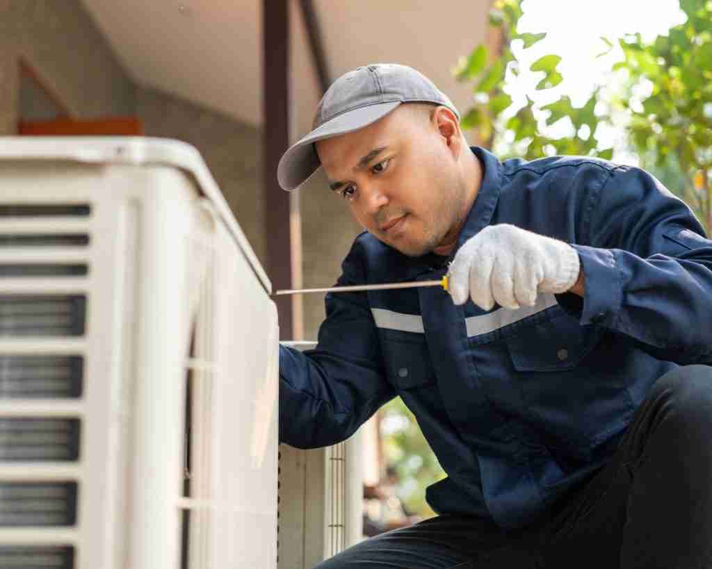 Technician working on AC unit