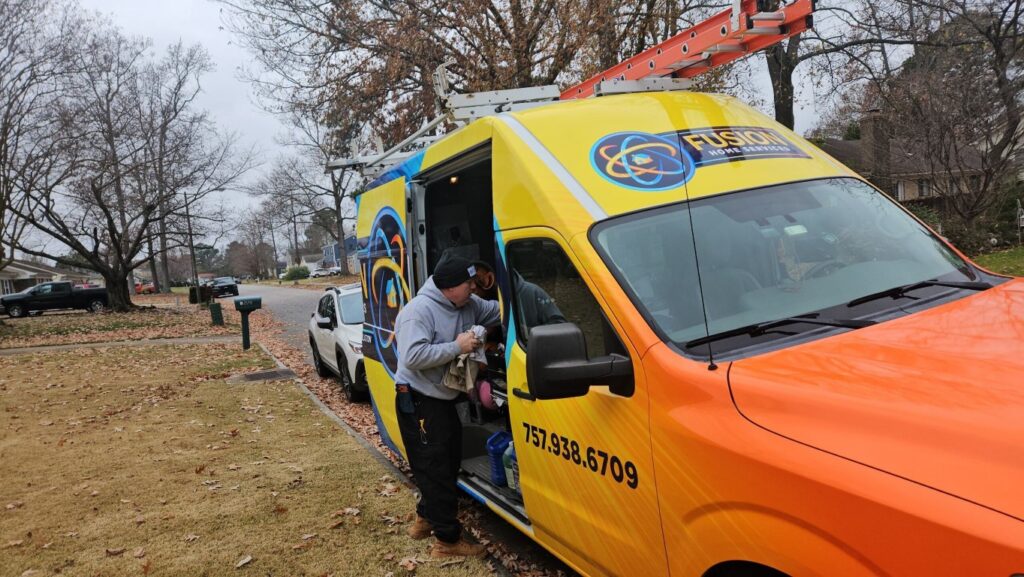 HVAC technician working on a service van for heating installation.