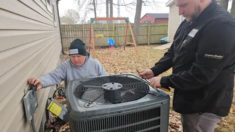 HVAC technician checking outdoor air conditioner unit for noise issues.